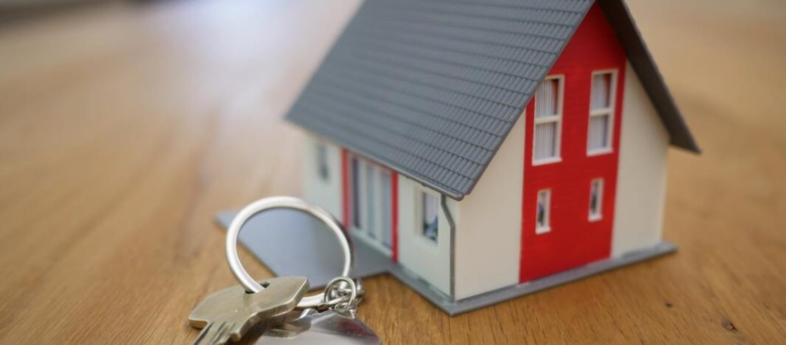 miniature house with a key beside it